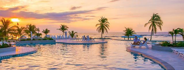 cayman brac pool beach sunset 1060x403 Min