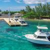 cayman brac boat leaving dock 1060x403 Min